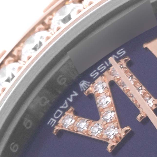 The image shows a close-up of a Rolex Mid-Size 278381RBR-0020 Women
s Steel and Gold (two tone) Purple Dial 278381RBR-0020 Women
s Steel and Gold (two tone) Purple Dial watch dial, highlighting the diamond-studded Roman numeral and part of the bezel.