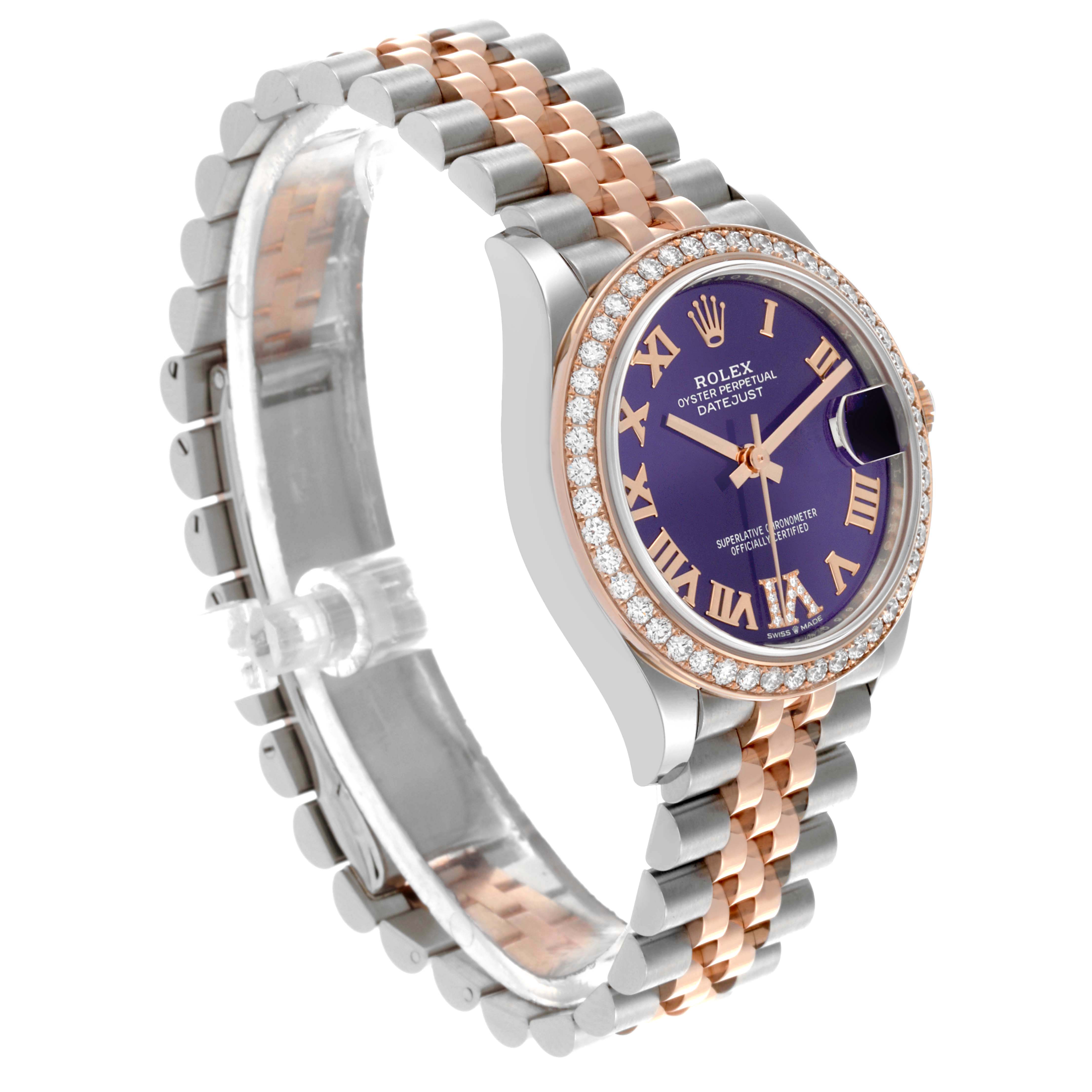 The Rolex Mid-Size 278381RBR-0020 Women's Steel and Gold (two tone) Purple Dial watch is shown at a three-quarter angle, highlighting its purple dial, diamond bezel, and two-tone bracelet.