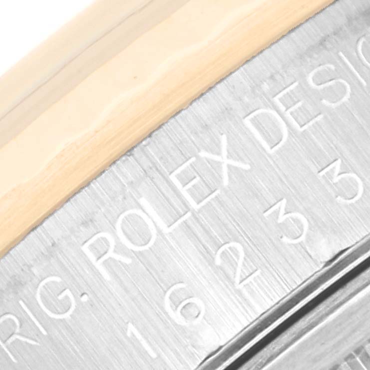 This image shows a close-up of the engraved casing of a Rolex Datejust 16233 Men's Steel and Gold (two tone) Black Dial 16233 Men's Steel and Gold (two tone) Black Dial watch.