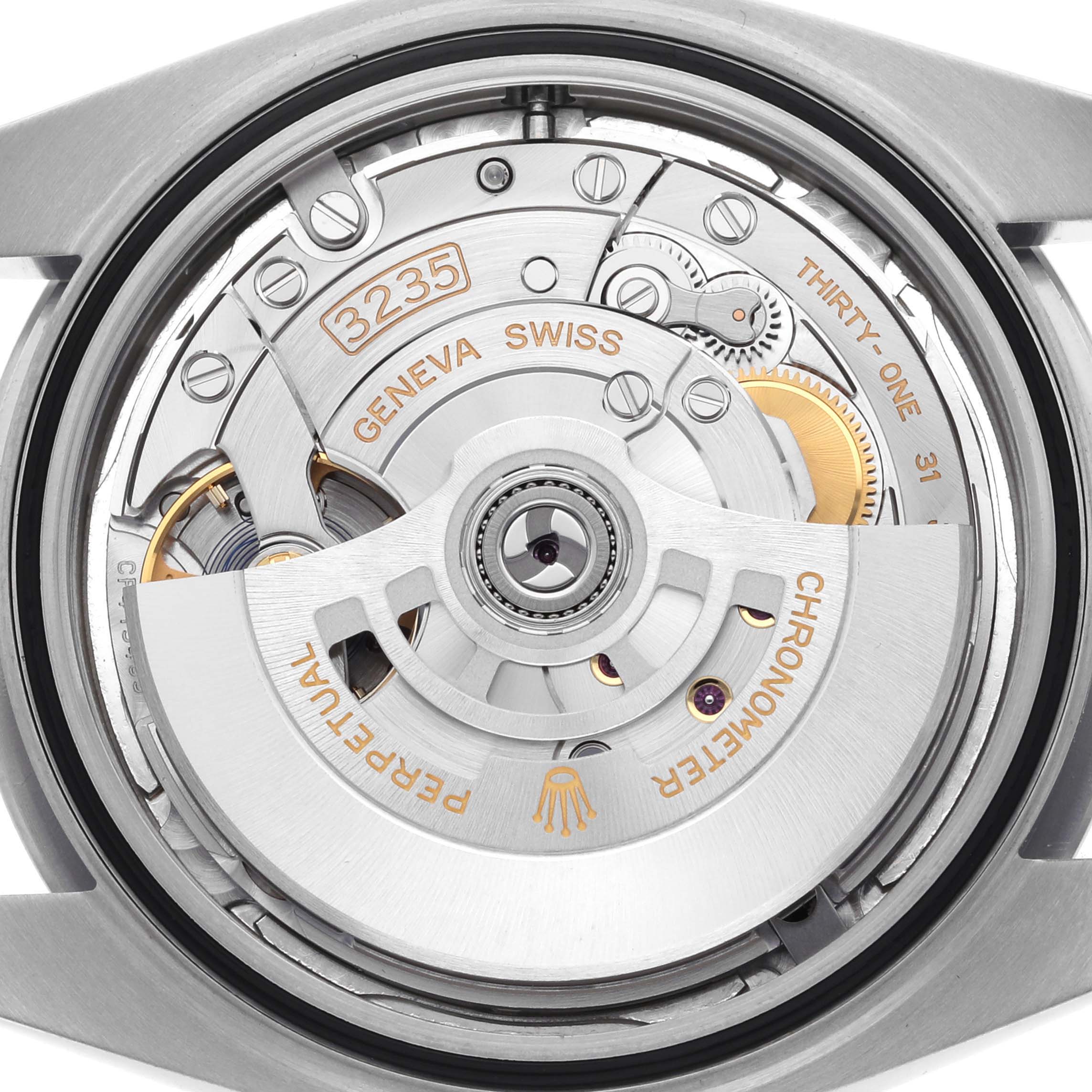 The image shows the movement of a Rolex Datejust 41 126300 Men
s Stainless Steel Silver Dial 126300 Men
s Stainless Steel Silver Dial, focusing on its intricate gears and rotors from the rear view.