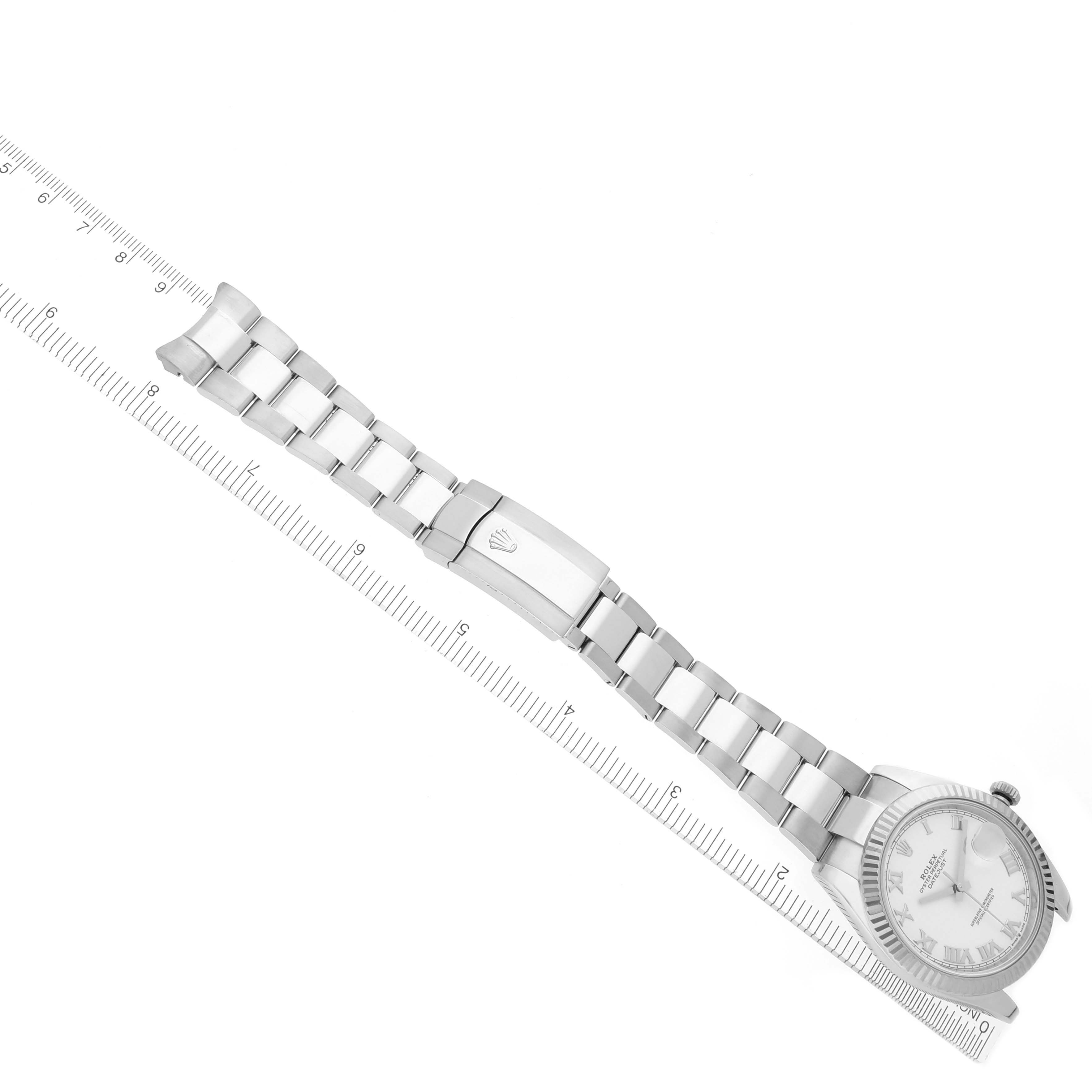 The image shows a top view of the Rolex Datejust 41 126334 Men's Stainless Steel White Dial 126334 Men's Stainless Steel White Dial watch with the bracelet extended alongside a ruler.