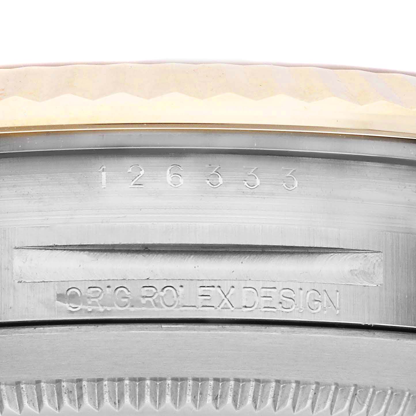 The image shows a close-up of the side of a Rolex Datejust 41 126333 Men's Steel and Gold (two tone) Grey Dial 126333 Men's Steel and Gold (two tone) Grey Dial, highlighting its case edge and engraved markings.