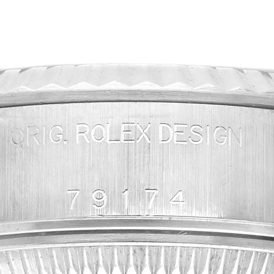 The image shows the side profile of the Rolex Datejust 79174 Women's Stainless Steel Black Dial 79174 Women's Stainless Steel Black Dial watch, focusing on the engraved model number and "Orig. Rolex Design."