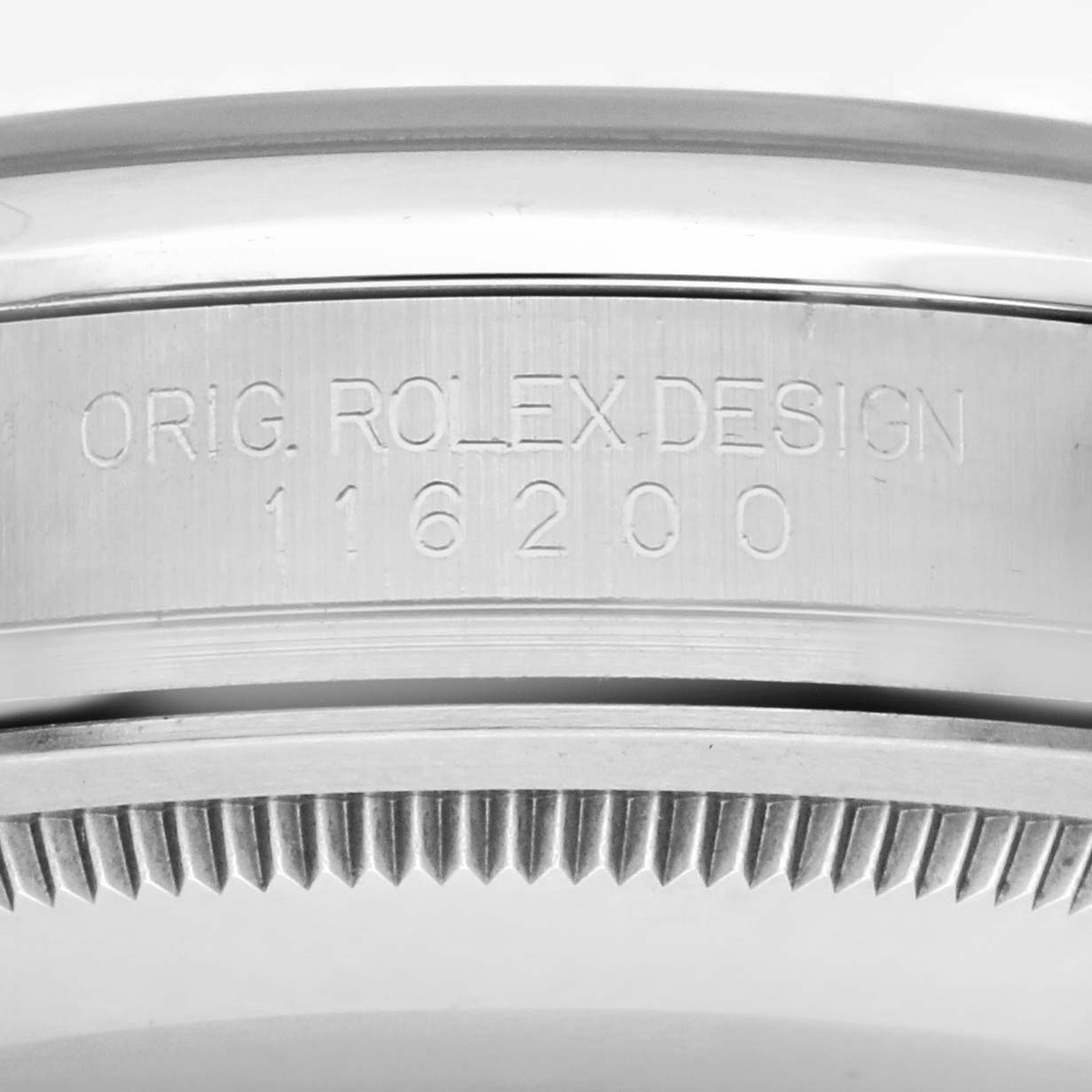 The image shows a close-up side view of the Rolex Datejust 116200 Men's Stainless Steel Blue Dial 116200 Men's Stainless Steel Blue Dial model's case edge, with the engraved reference number.
