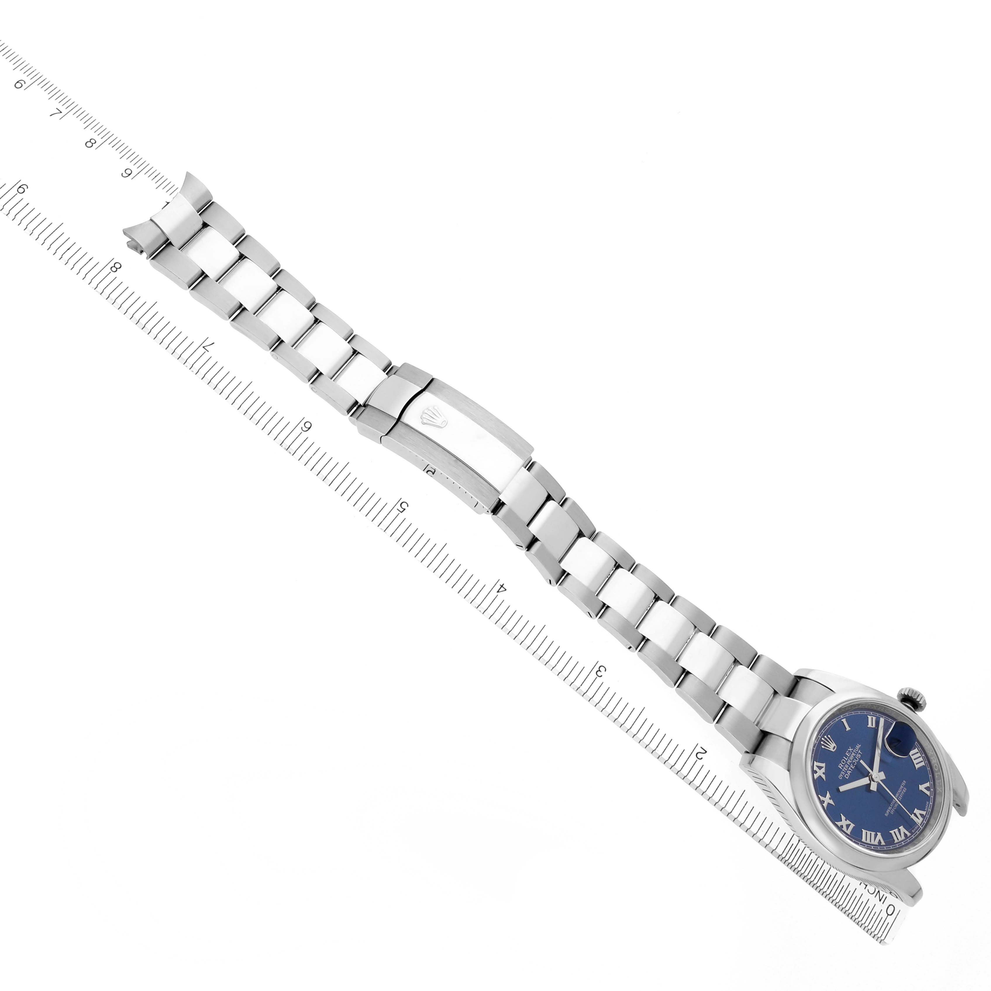 The image shows a Rolex Datejust 116200 Men's Stainless Steel Blue Dial 116200 Men's Stainless Steel Blue Dial watch from a top-down angle, highlighting the bracelet, clasp, and blue dial.