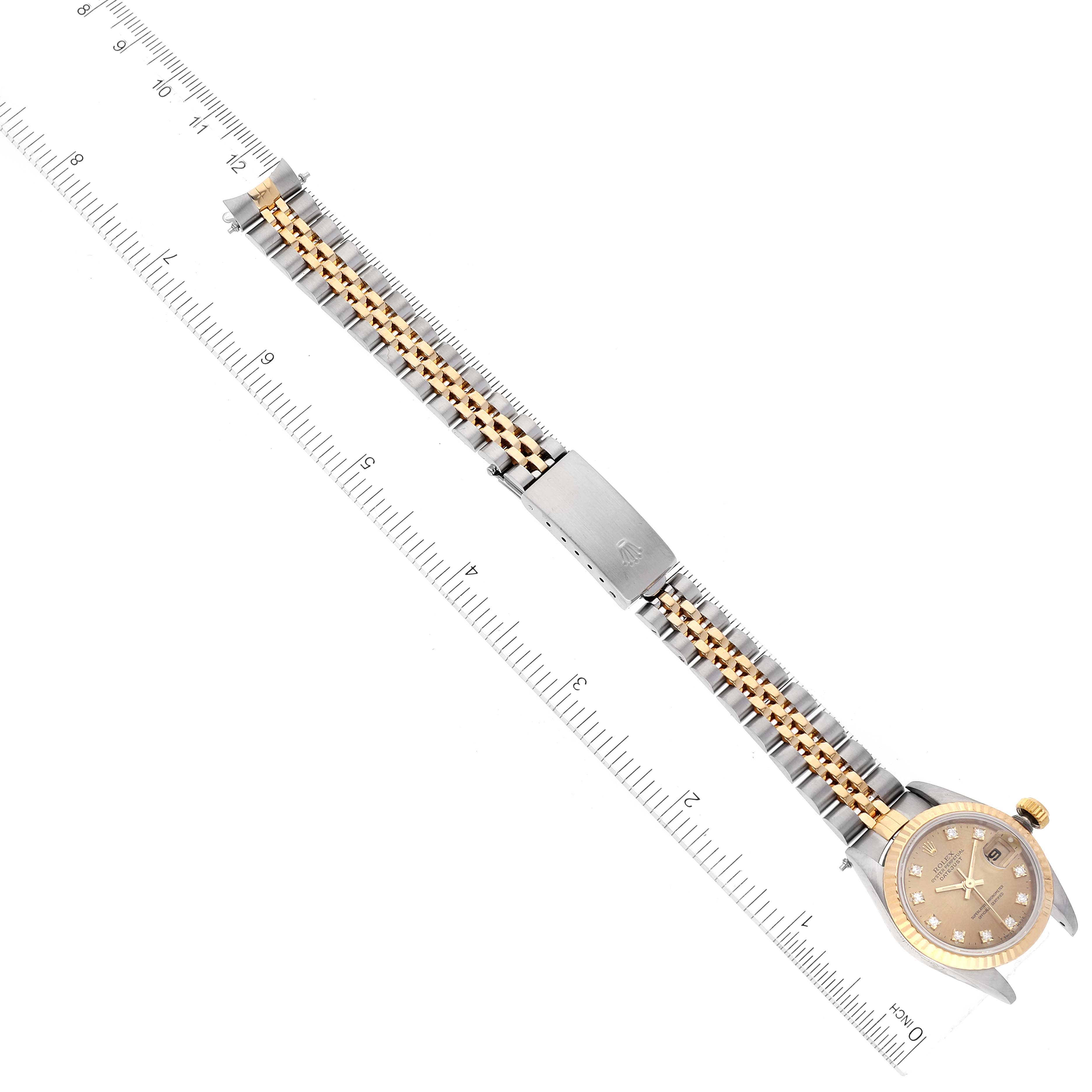The Rolex Datejust 69173 Women's Steel and Gold (two tone) Champagne Dial 69173 Women's Steel and Gold (two tone) Champagne Dial watch is shown from a top-down angle, displaying its face, bracelet, and clasp.