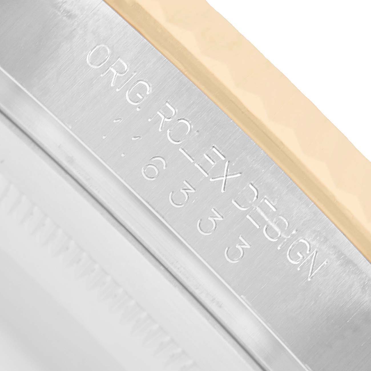 The image shows a close-up of the edge and engraved text on the case of a Rolex Datejust 41 116333 Men's Steel and Gold (two tone) Black Dial watch.