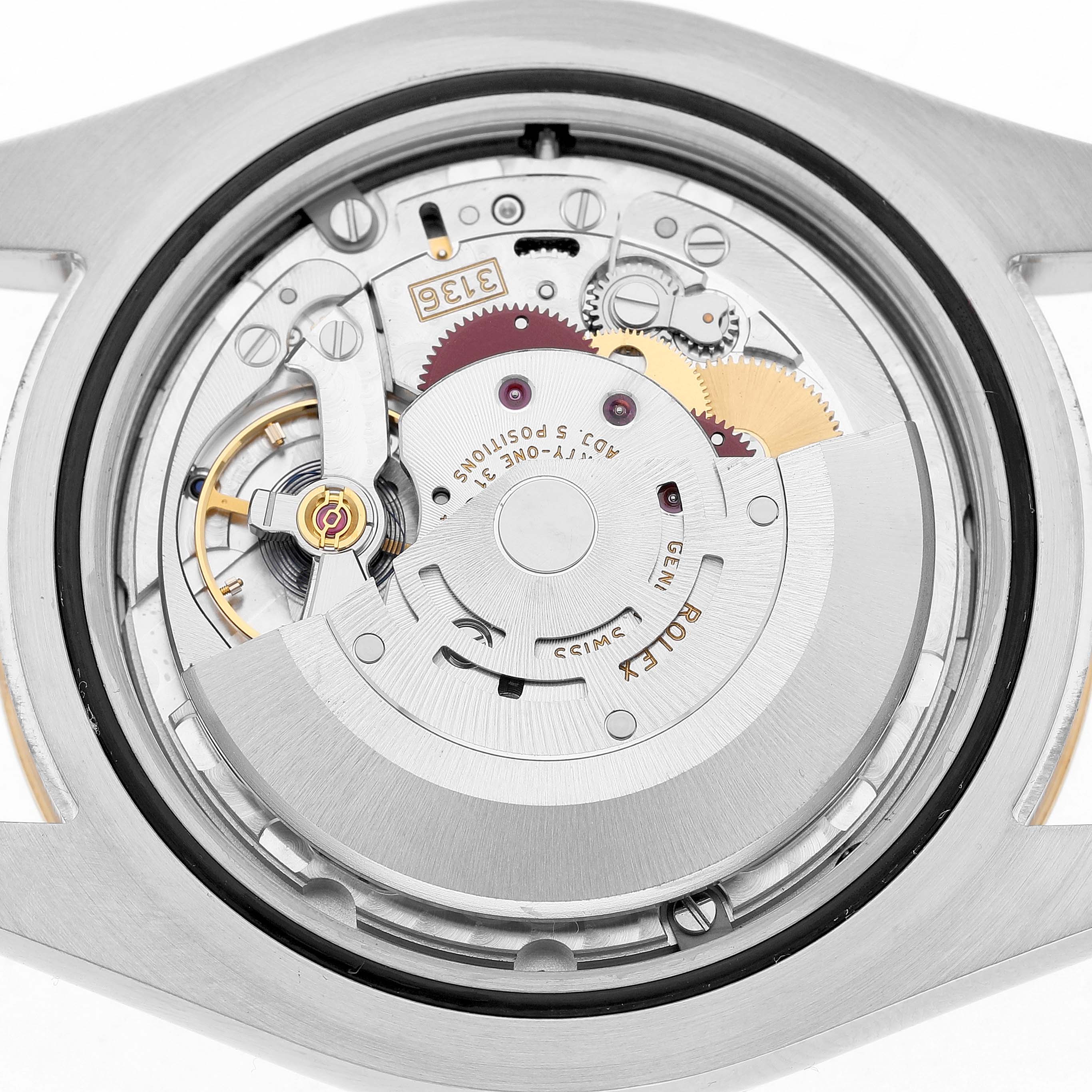 The image shows the movement of a Rolex Datejust 41 116333 Men's Steel and Gold (two tone) Black Dial viewed from the back, highlighting its intricate gears and components.