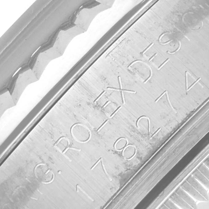 The image shows a close-up of the engraved bezel of a Rolex Mid-Size 178274 Women's Stainless Steel Mother of Pearl Dial 178274 Women's Stainless Steel Mother of Pearl Dial model, focusing on the branding and numbers.