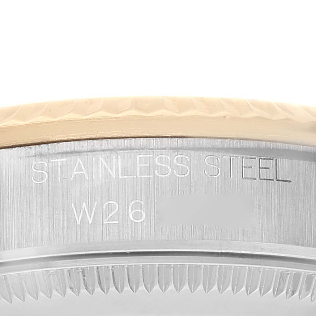 This image shows a close-up view of the case-back rim and bezel of a Mid-Size Rolex watch, highlighting the stainless steel material.