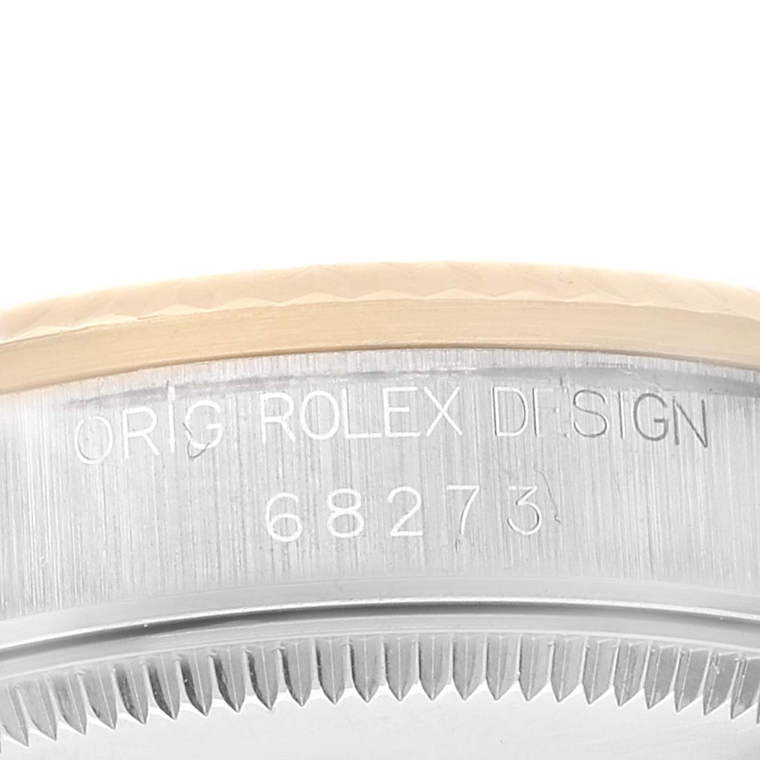 This close-up image shows the side of a Mid-Size Rolex watch case, focusing on the engraved model number and "ORIG ROLEX DESIGN" text.