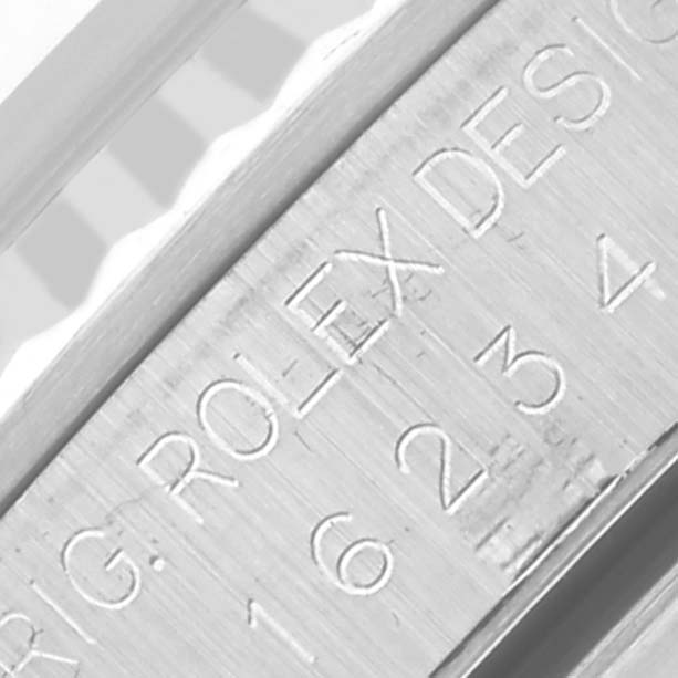 The image shows an engraving on the case's side of a Rolex Datejust 16234G Men's Stainless Steel Mother of Pearl Dial 16234G Men's Stainless Steel Mother of Pearl Dial, highlighting serial or model details.