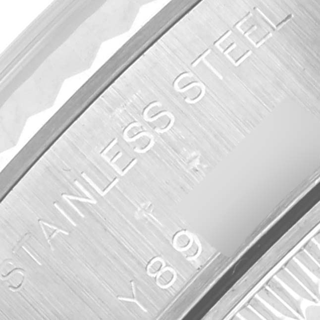 The image shows a close-up of the Rolex Datejust 79174 Women's Stainless Steel Silver Dial 79174 Women's Stainless Steel Silver Dial watch's stainless steel case with engraved text visible.
