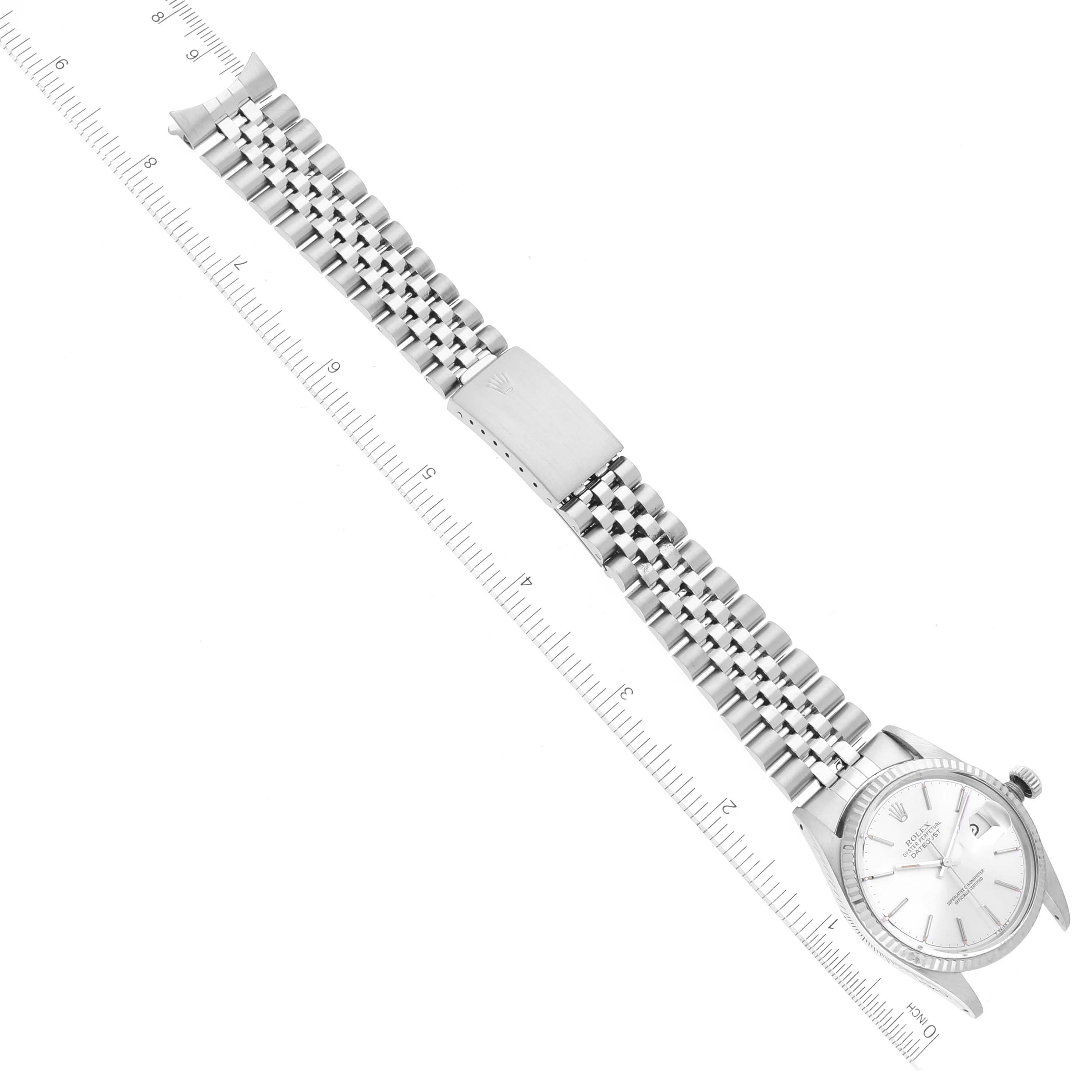 The image shows the Rolex Vintage Collection 16014 Men
s Stainless Steel Silver Dial 16014 Men
s Stainless Steel Silver Dial watch and its metal bracelet laid flat next to a ruler for measurement.