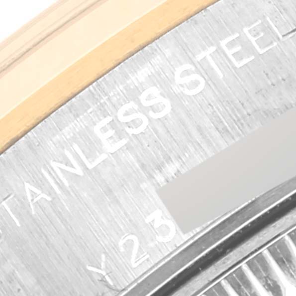 A close-up of the case back and part of the bracelet of a Rolex Datejust 79163 Women's Steel and Gold (two tone) Champagne Dial 79163 Women's Steel and Gold (two tone) Champagne Dial watch showing the engraving "STAINLESS STEEL."