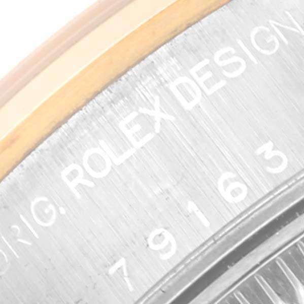 This image shows a close-up of the side engraving on the case of a Rolex Datejust 79163 Women's Steel and Gold (two tone) Champagne Dial 79163 Women's Steel and Gold (two tone) Champagne Dial watch.