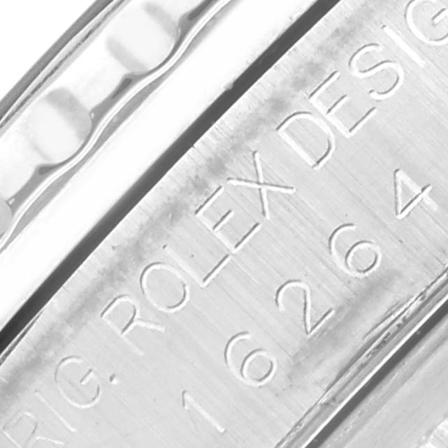 The image shows a close-up of the engraved inner bezel of a Rolex Datejust watch.