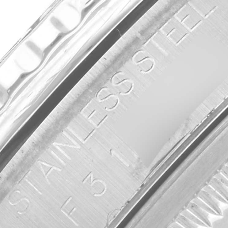 The image shows a close-up of the Rolex Datejust's stainless steel case with visible engravings.