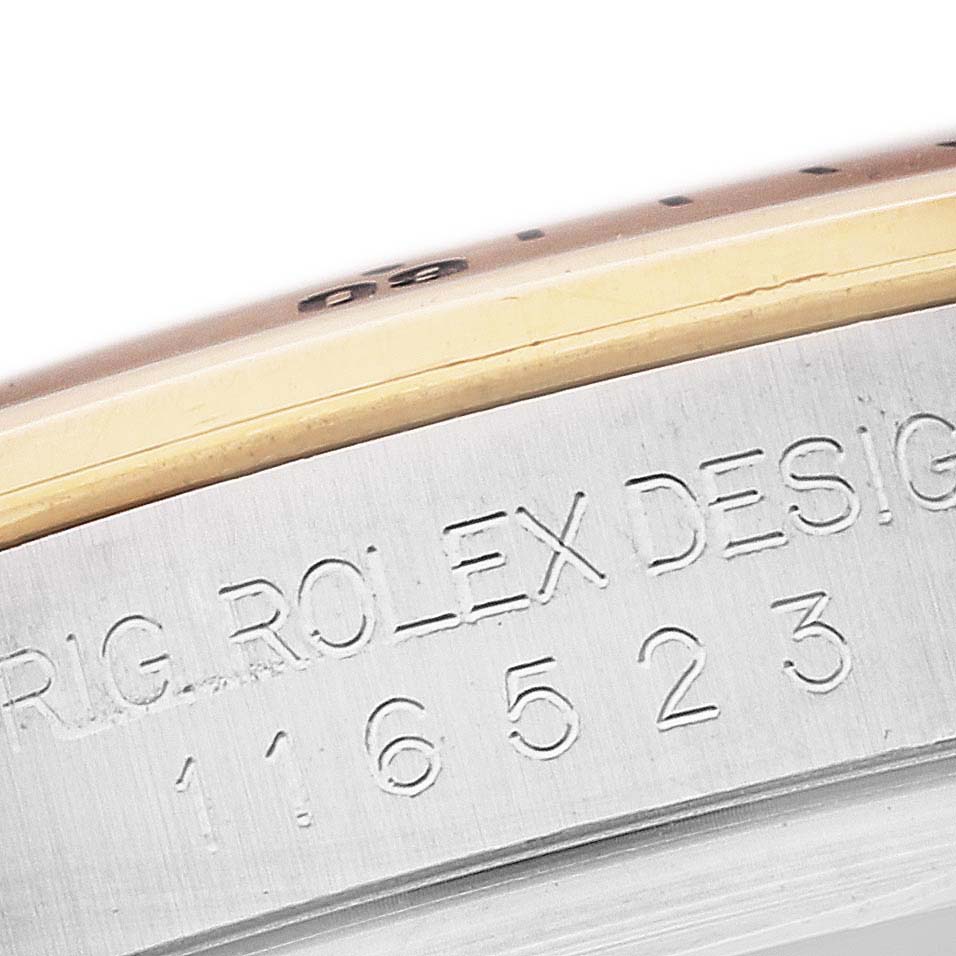 This close-up angle shows the engraved case side with model number of a Rolex Daytona 116523 Men's Steel and Gold (two tone) Silver Dial 116523 Men's Steel and Gold (two tone) Silver Dial watch.
