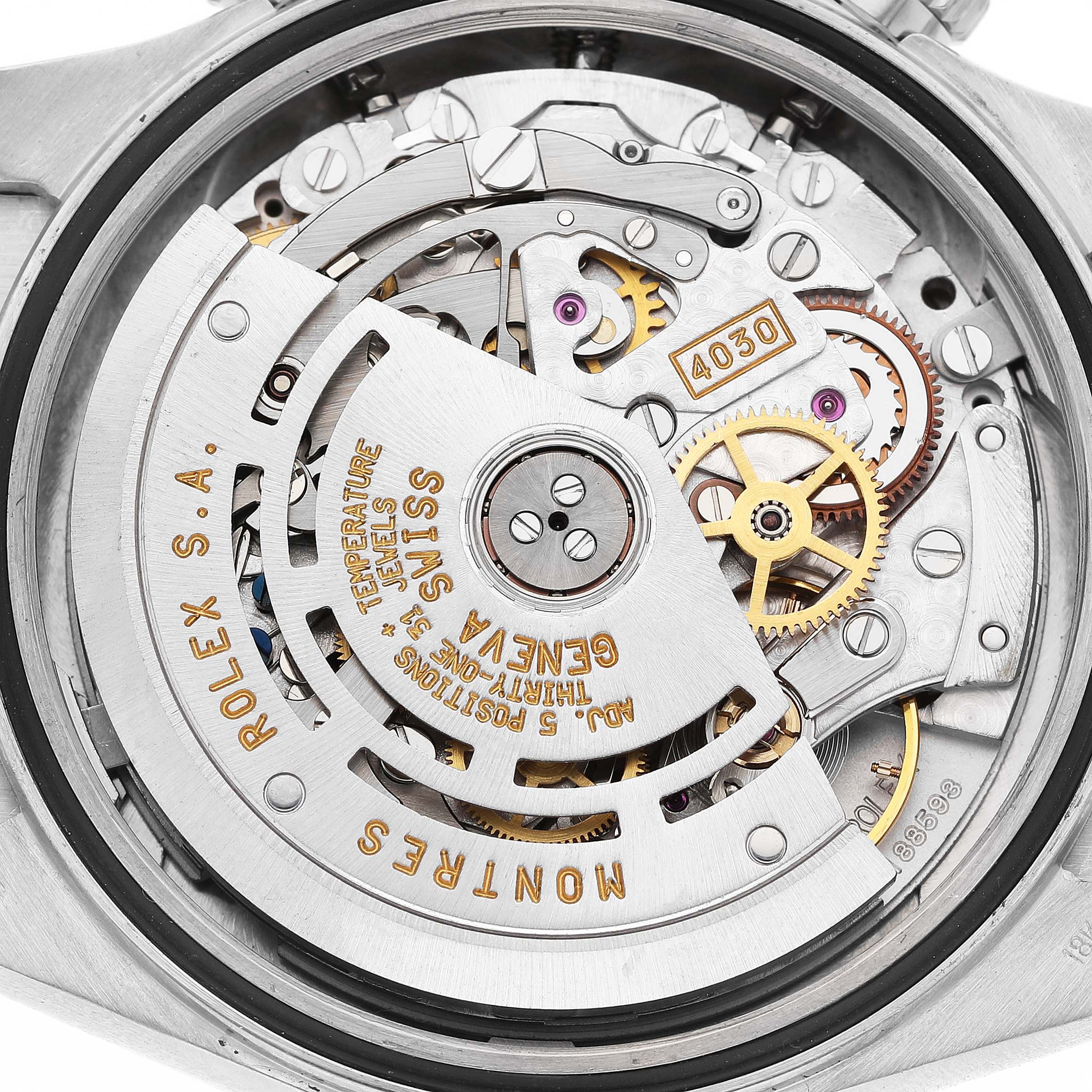 This image shows the movement and internal mechanics of a Rolex Daytona 16589 Men's White Gold Mother of Pearl Dial watch from a rear angle, highlighting gears and inscriptions.