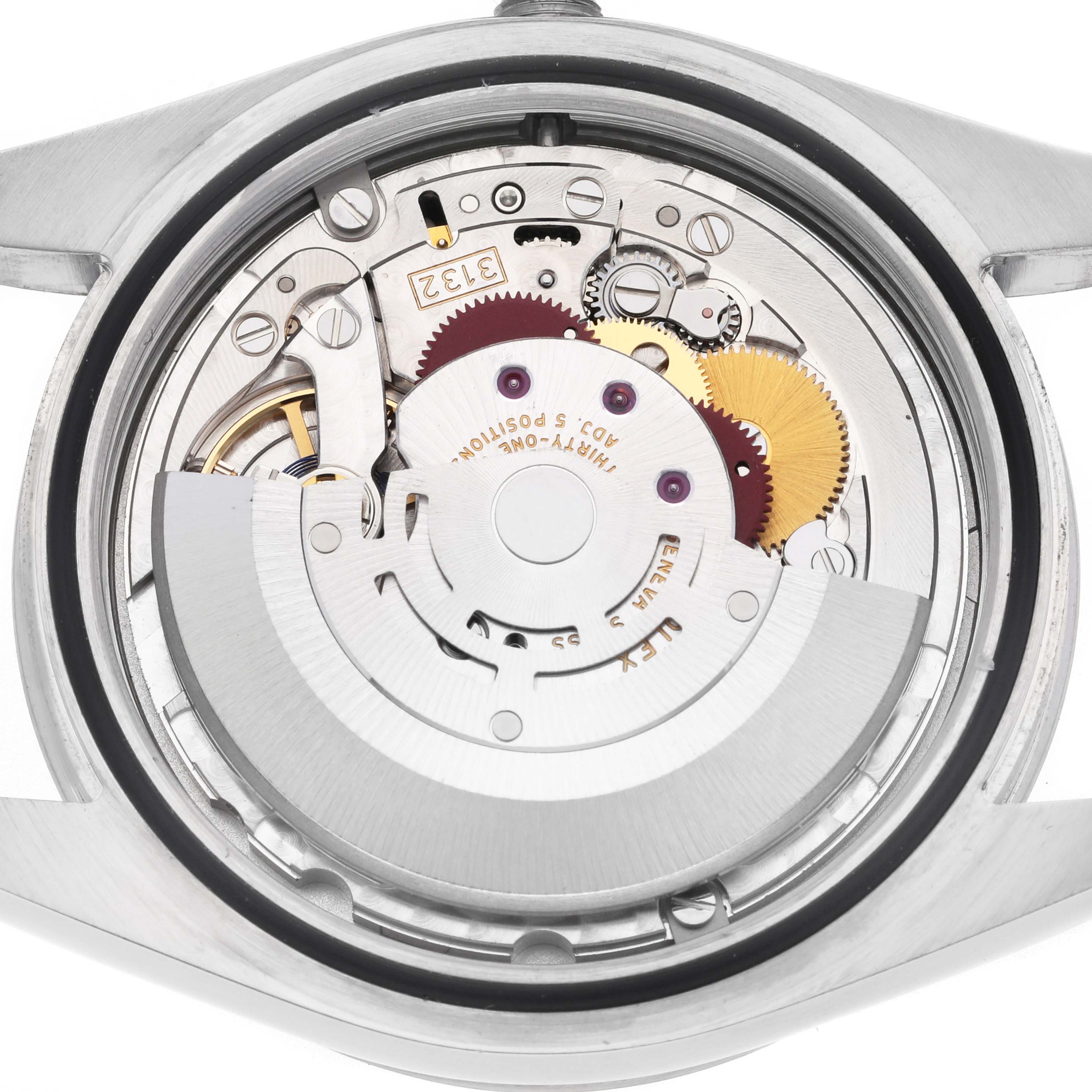 The image shows the movement of a Rolex Explorer 214270 Men's Stainless Steel Black Dial 214270 Men's Stainless Steel Black Dial watch from a back view, highlighting its intricate gears and mechanisms.