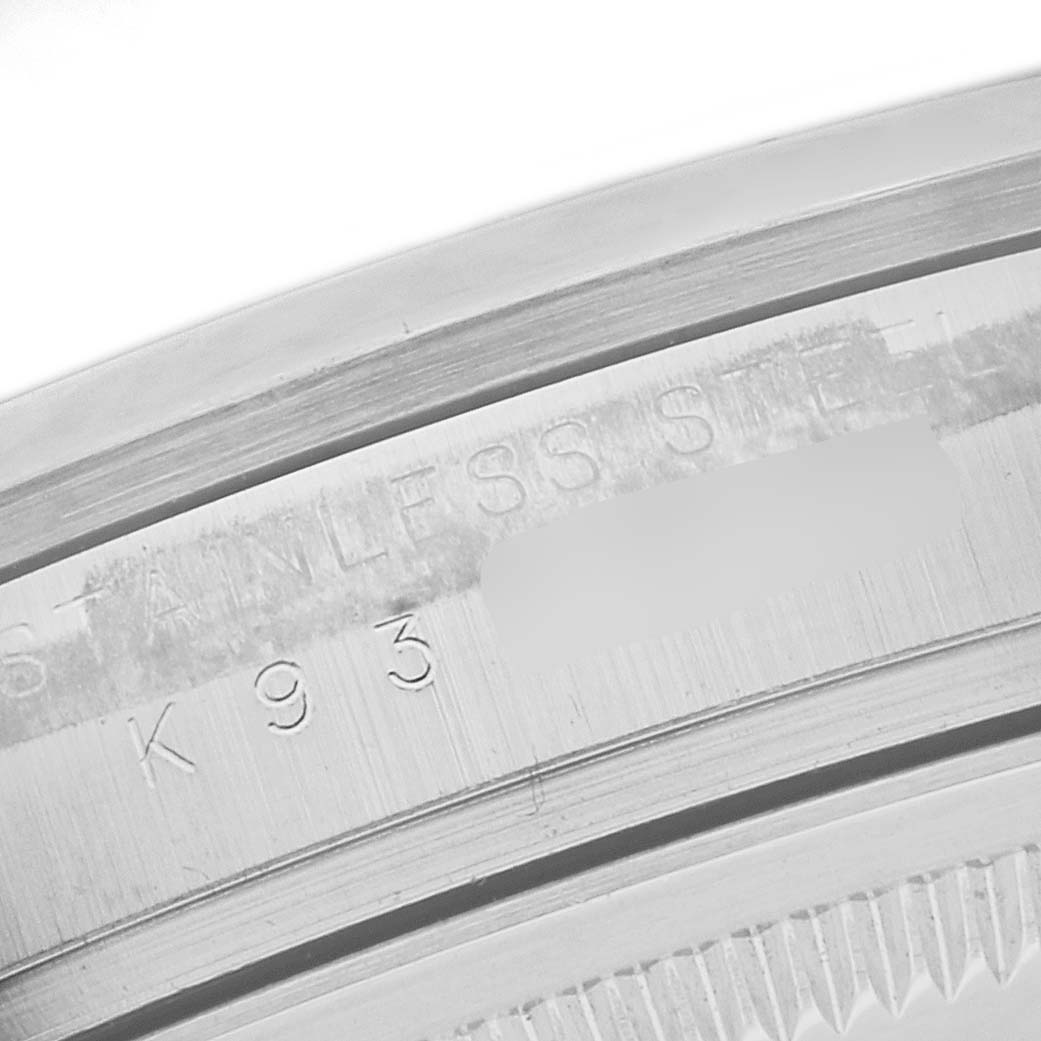 This close-up image shows the engravings on the side of the stainless steel bezel of a Rolex Explorer 114270 Men's Stainless Steel Black Dial 114270 Men's Stainless Steel Black Dial watch.
