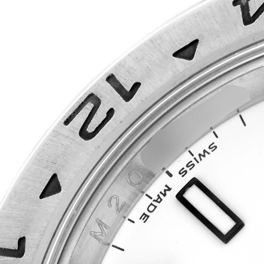 The image shows a close-up of the bezel, numerals, and part of the dial of a Rolex Explorer 16570 Men's Stainless Steel White Dial 16570 Men's Stainless Steel White Dial watch.