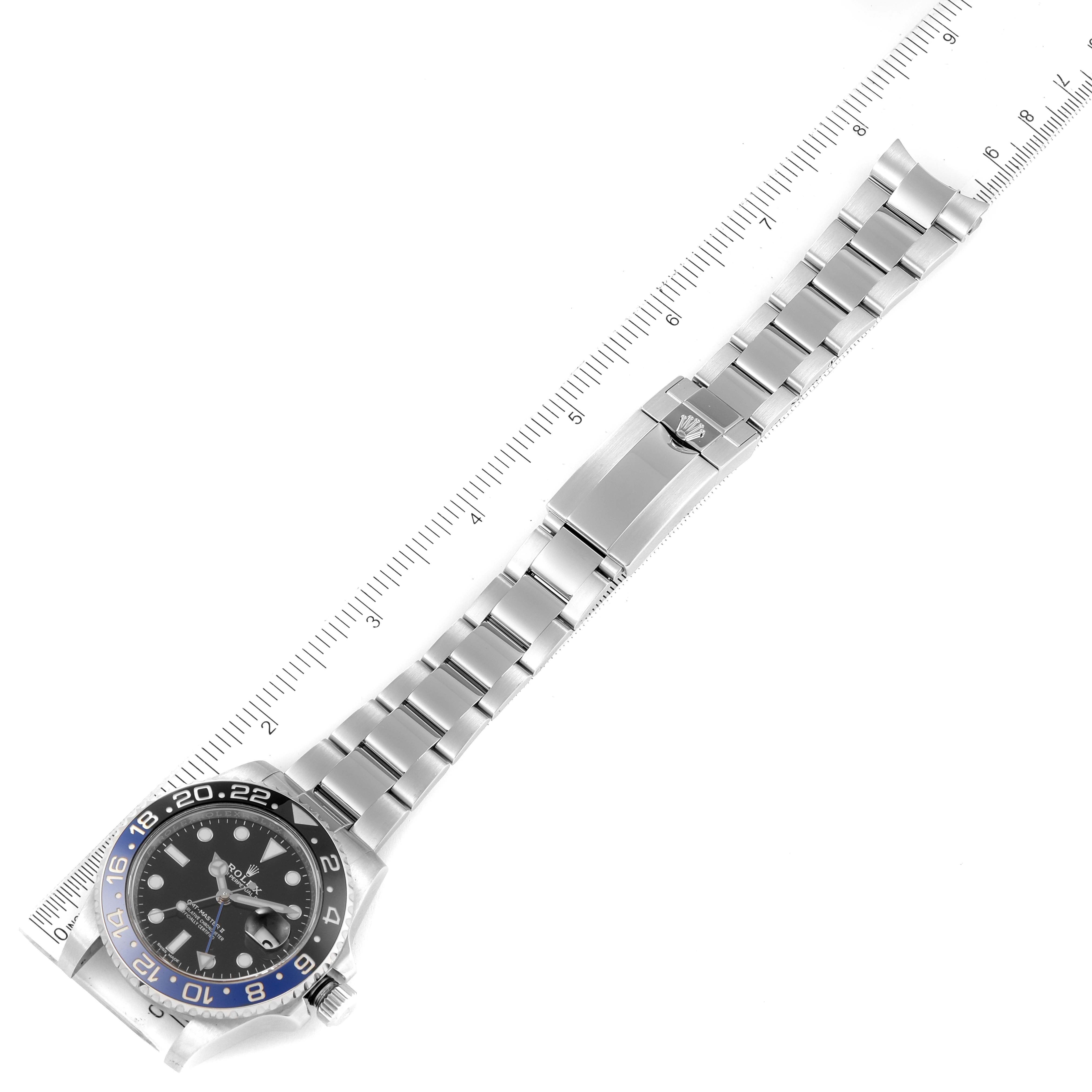 The image shows a top-down view of a Rolex GMT-Master 116710 Men
s Stainless Steel Black Dial 116710 Men
s Stainless Steel Black Dial watch, displaying the face, bezel, and full bracelet alongside a ruler.
