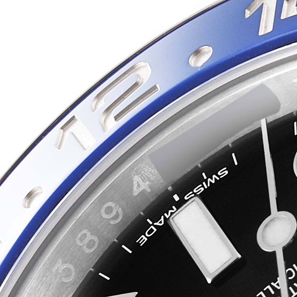 The image shows a close-up of the bezel and part of the dial of a Rolex GMT-Master 116710 Men
s Stainless Steel Black Dial 116710 Men
s Stainless Steel Black Dial watch, highlighting the "Swiss Made" text.