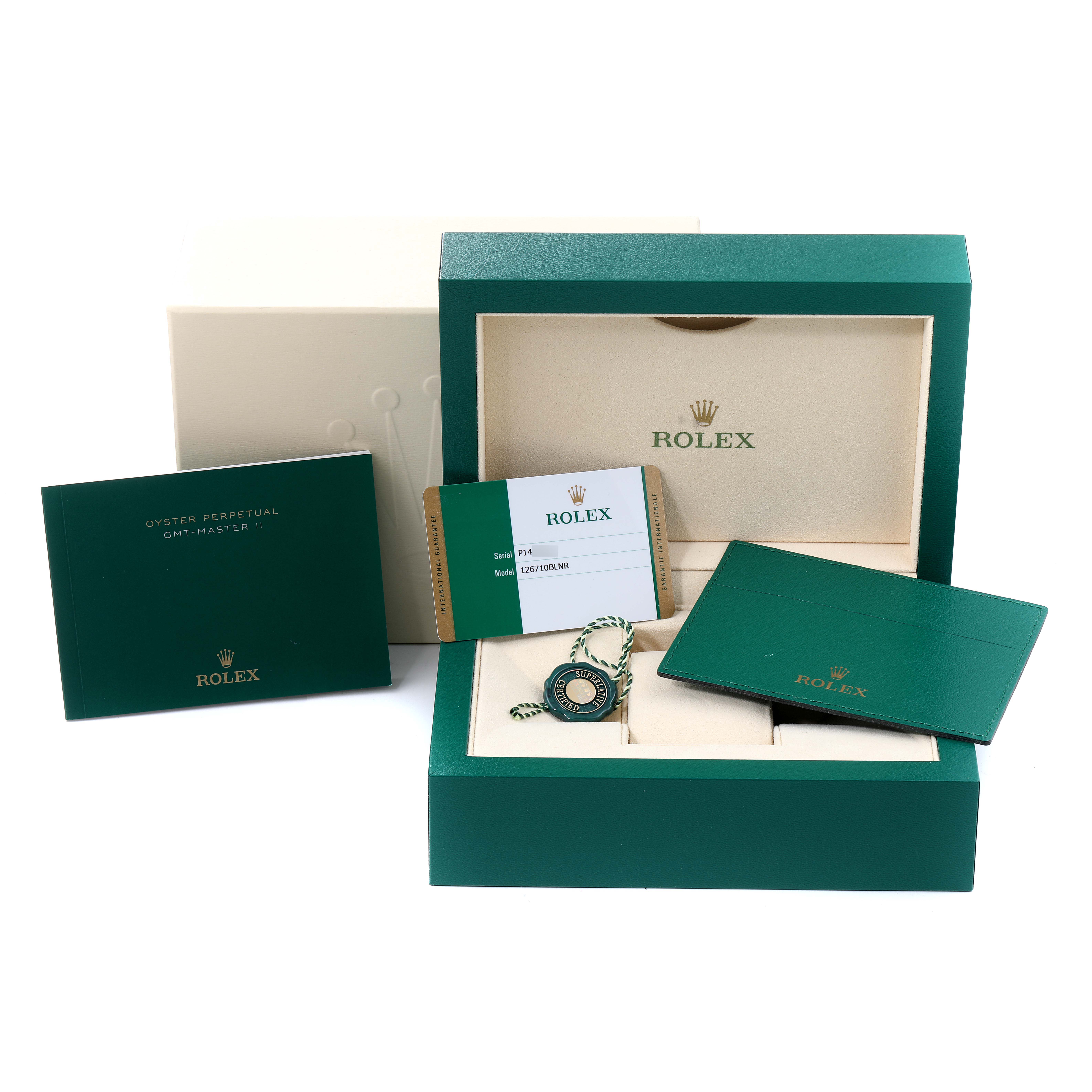 The image shows the packaging and accessories of a Rolex GMT-Master 126710 Men
s Stainless Steel Black Dial 126710 Men
s Stainless Steel Black Dial watch, including the box, manuals, warranty card, and accessories.