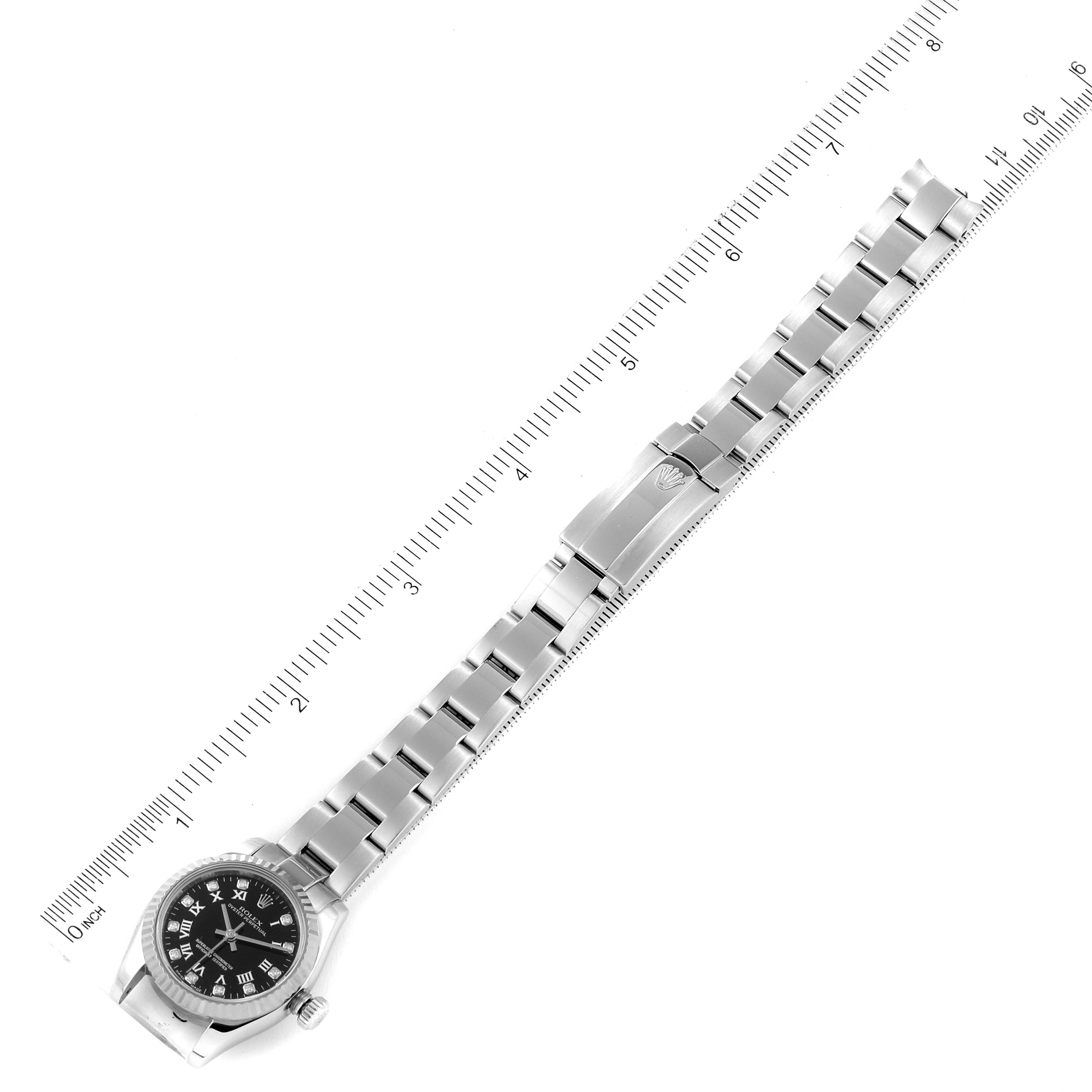 The image shows a top-down view of a Rolex Oyster Perpetual 176234 Women's Stainless Steel Black Dial 176234 Women's Stainless Steel Black Dial watch with a metal band next to a ruler, highlighting its length.