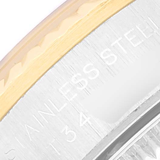 This close-up image shows part of the bezel and engraved "STAINLESS STEEL" text on a Rolex Oyster Perpetual 67193 Women's Steel and Gold (two tone) Champagne Dial 67193 Women's Steel and Gold (two tone) Champagne Dial watch.