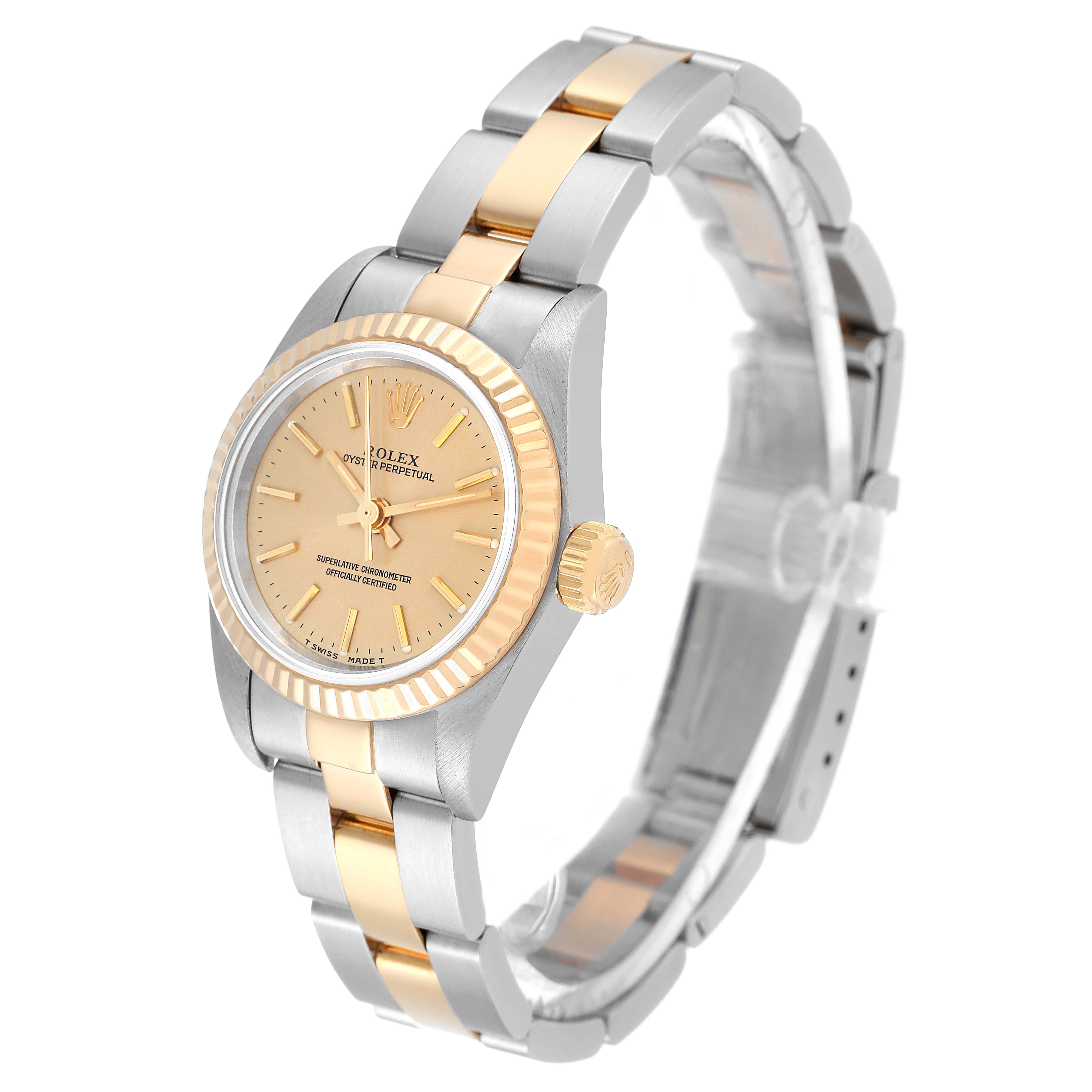 This image shows a side angle of the Rolex Oyster Perpetual 67193 Women's Steel and Gold (two tone) Champagne Dial 67193 Women's Steel and Gold (two tone) Champagne Dial, highlighting the watch face, bezel, crown, and bracelet.