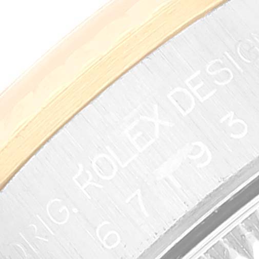 The image shows a close-up angle of the bezel and the engraved markings on the side of a Rolex Oyster Perpetual 67193 Women's Steel and Gold (two tone) Champagne Dial 67193 Women's Steel and Gold (two tone) Champagne Dial watch.