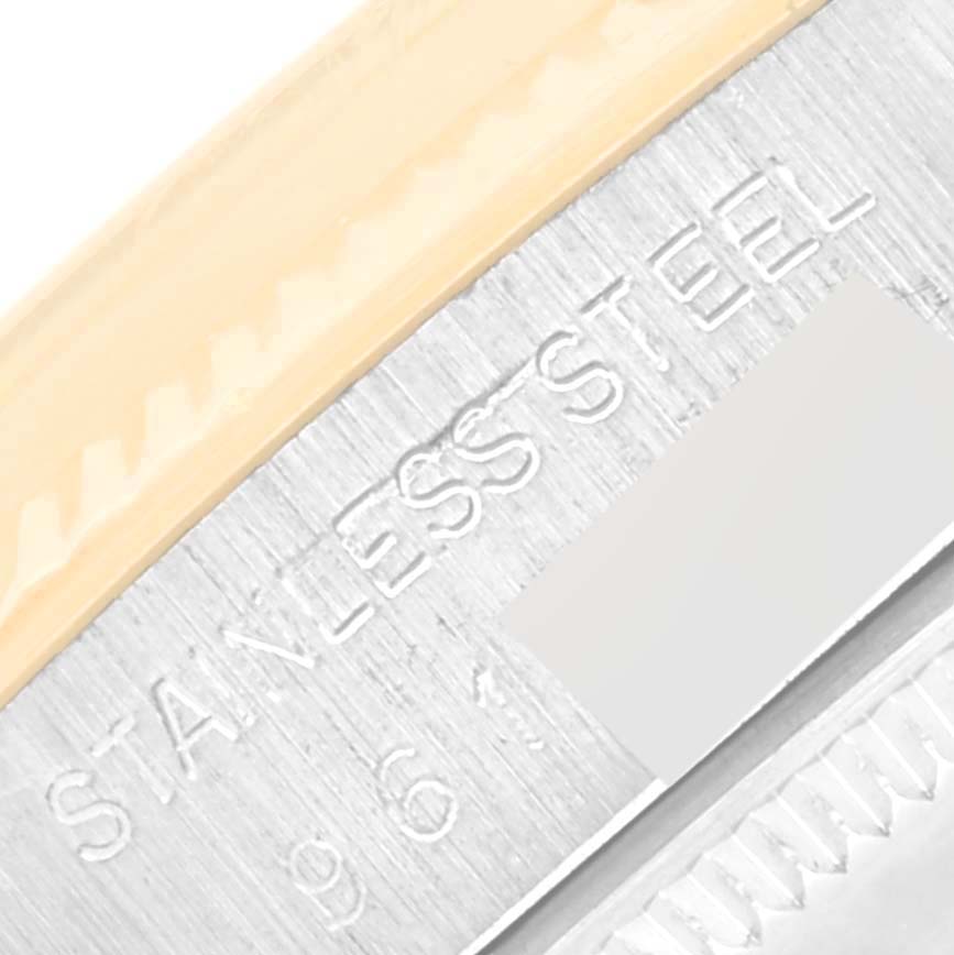 This close-up image shows the edge of the Rolex Vintage Collection 1005 Men's Steel and Gold (two tone) Champagne Dial 1005 Men's Steel and Gold (two tone) Champagne Dial watch case, highlighting the stainless steel marking.