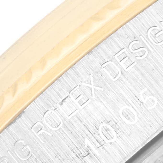 This is a close-up of the engraved casing of a Vintage Collection model watch by Rolex.