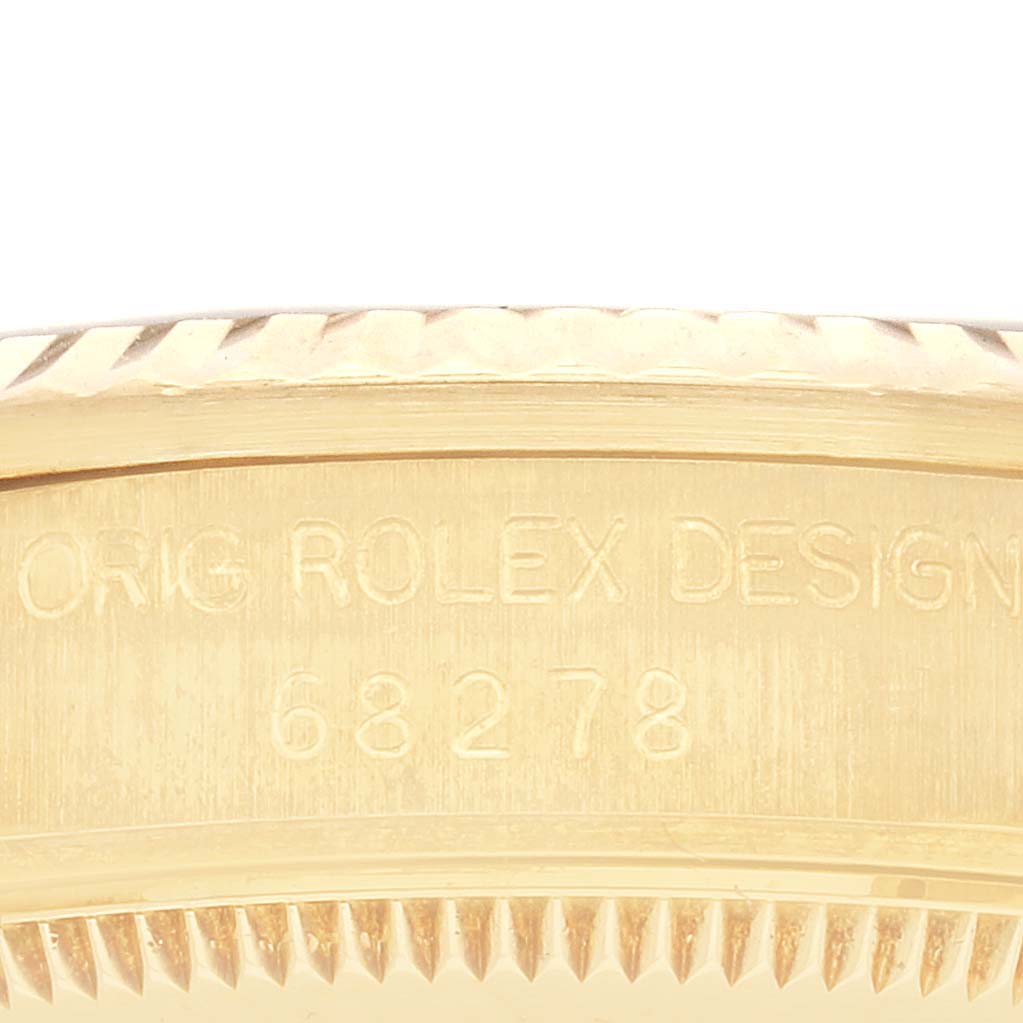 This image shows a close-up of the Rolex President 68278 Women's Yellow Gold Red Dial 68278 Women's Yellow Gold Red Dial model's side, highlighting the engraved model number.