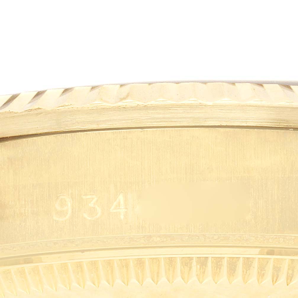 The image shows the side of a Rolex President 68278 Women's Yellow Gold Red Dial 68278 Women's Yellow Gold Red Dial watch, focusing on the engraved details on the case band.