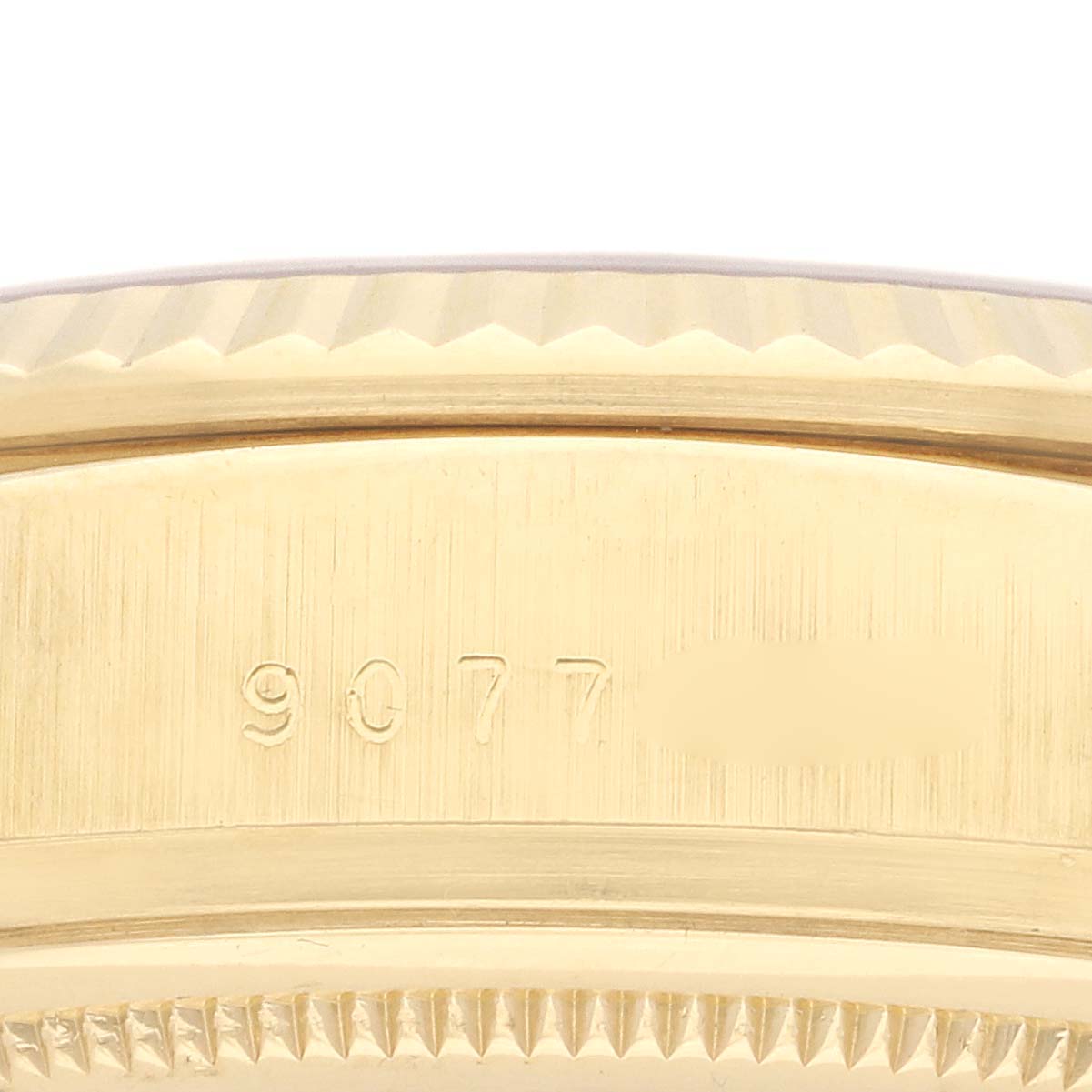 The image shows a close-up of the Rolex President 18038 Men's Yellow Gold Silver Dial 18038 Men's Yellow Gold Silver Dial model's gold bezel and part of the case, highlighting its fluted design.
