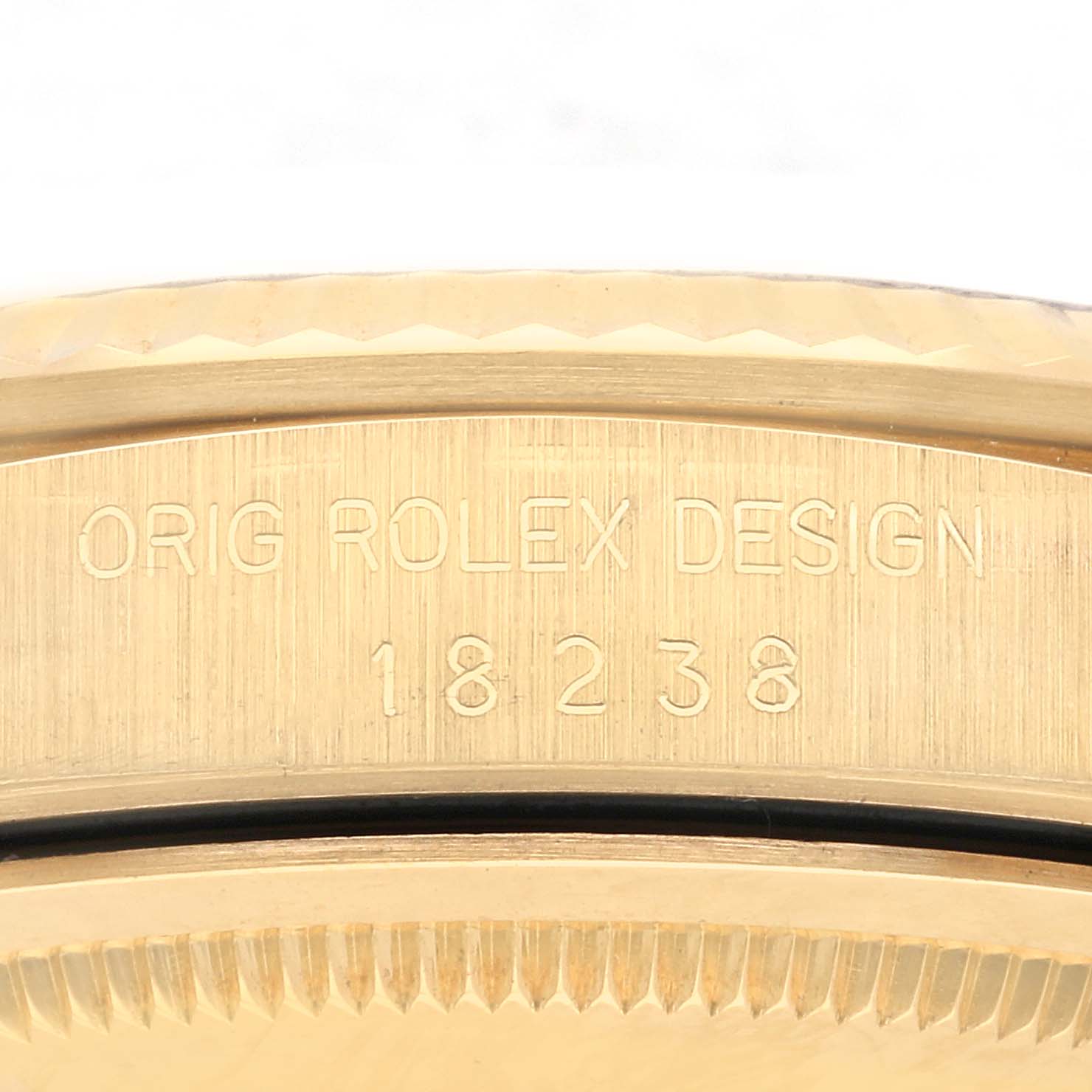 The image shows an angled close-up of the case side on a Rolex President 18238 Men's Yellow Gold Champagne Dial 18238 Men's Yellow Gold Champagne Dial model, featuring its engravings.