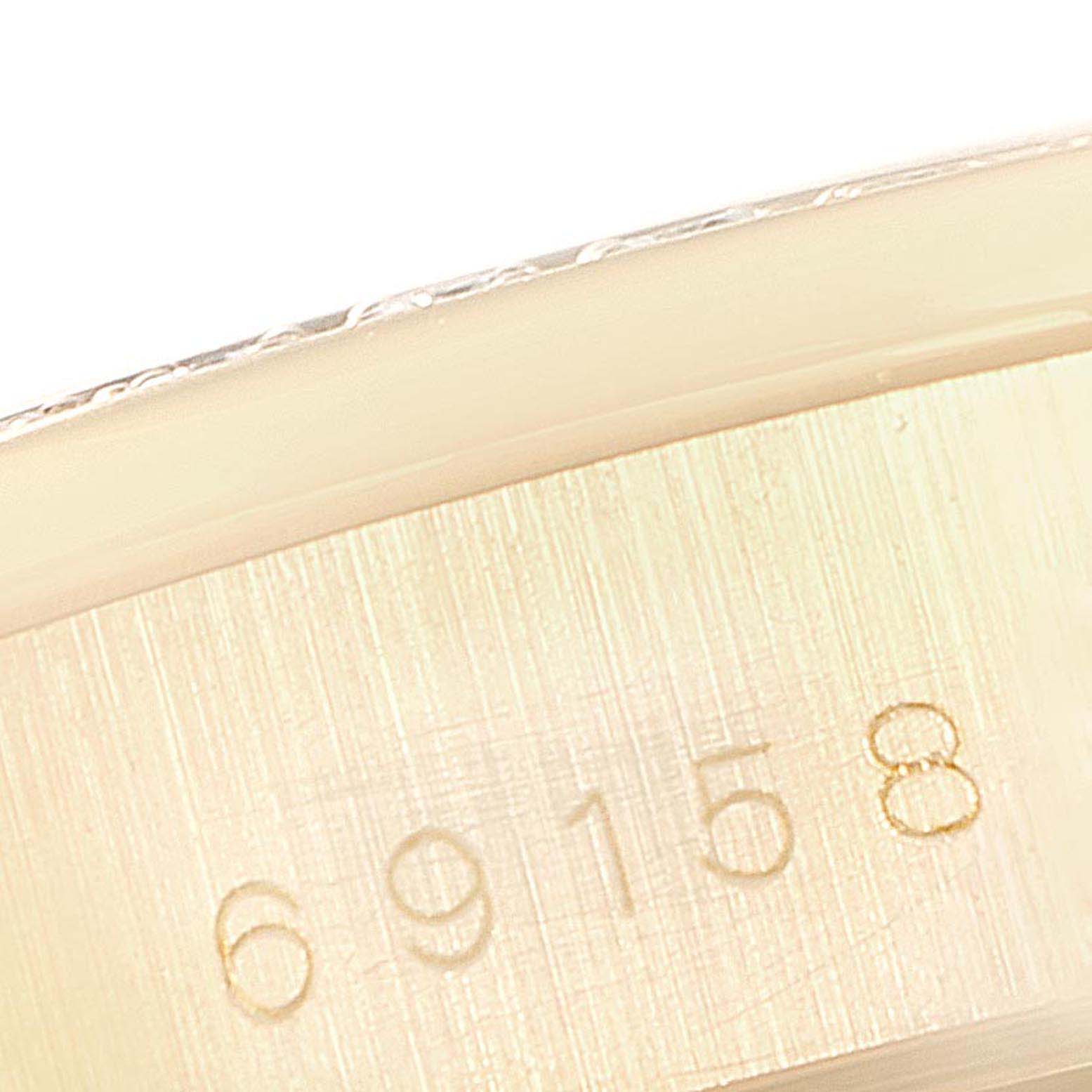 This image shows a close-up of the serial number engraved on the case of a Rolex President 69158 Women's Yellow Gold Silver Dial 69158 Women's Yellow Gold Silver Dial model watch.