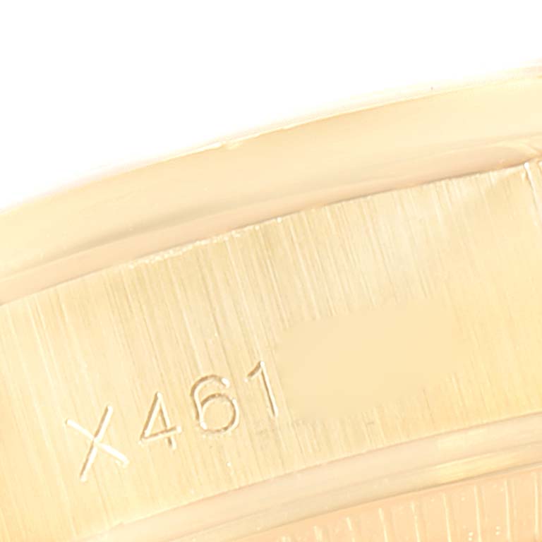 This image shows a close-up of the serial number engraving on the case of a Rolex President 69158 Women's Yellow Gold Silver Dial 69158 Women's Yellow Gold Silver Dial model watch.