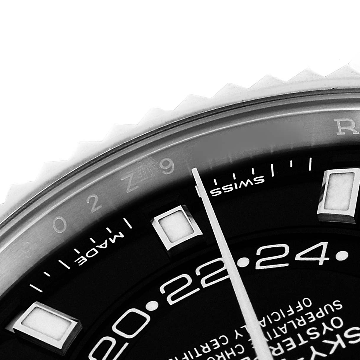 This close-up shows the dial, indices, and part of the bezel of the Rolex Sky-Dweller 326934 Men's Stainless Steel Black Dial 326934 Men's Stainless Steel Black Dial watch.