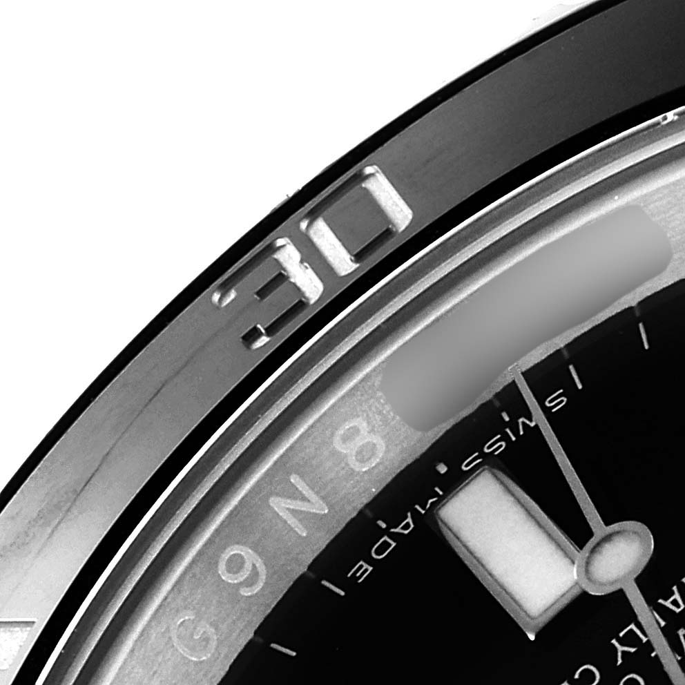This image shows a close-up of the bezel, part of the dial, and the minute hand of a Rolex Submariner 116610 Men
s Stainless Steel Black Dial 116610 Men
s Stainless Steel Black Dial watch.