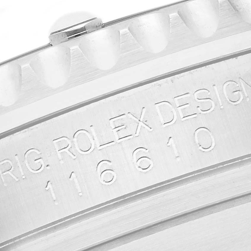 The image shows a close-up of the engraved side of a Rolex Submariner 116610LV Men's Stainless Steel Green Dial 116610LV Men's Stainless Steel Green Dial model 116610 bezel.