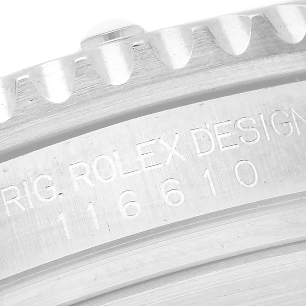 The image shows a close-up angle of the Rolex Submariner 116610LV Men's Stainless Steel Green Dial 116610LV Men's Stainless Steel Green Dial model's engraved side, highlighting the serial number and design details.