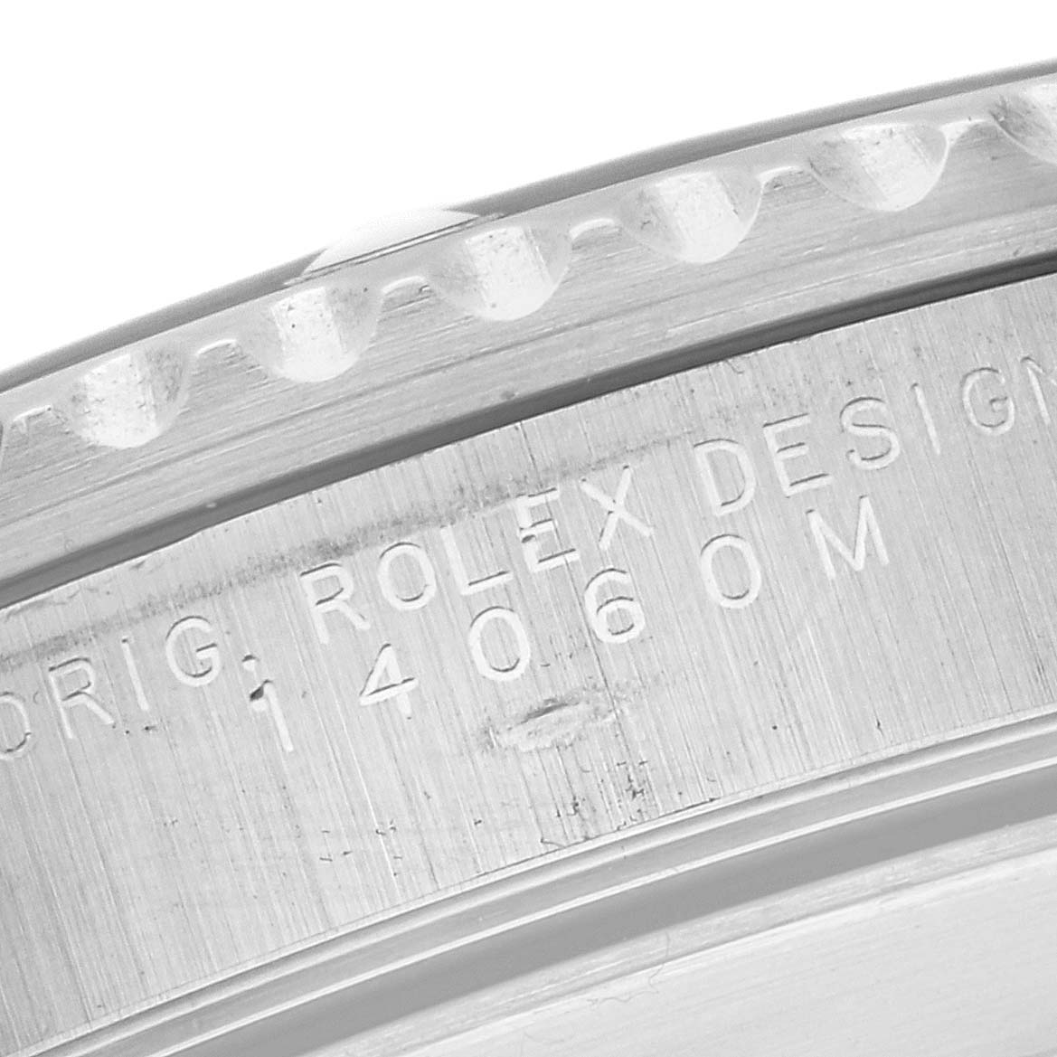 This image shows a close-up of the engraved side of the bezel and case back on a Rolex Submariner 14060M Men
s Stainless Steel Black Dial 14060M Men
s Stainless Steel Black Dial watch.