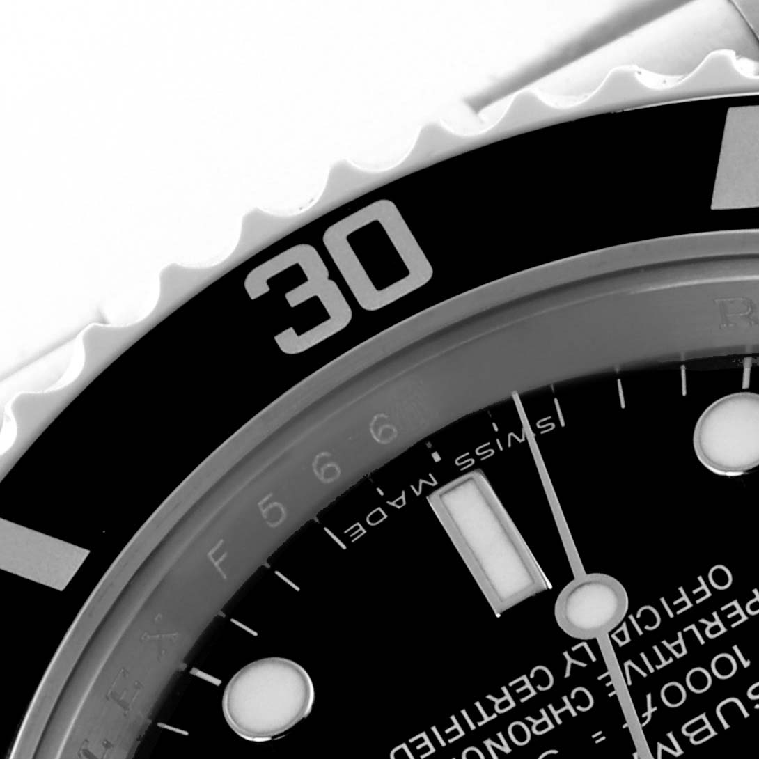 The image shows a close-up of the Rolex Submariner 14060M Men's Stainless Steel Black Dial 14060M Men's Stainless Steel Black Dial's bezel and part of the dial, focusing on the 30-minute mark.