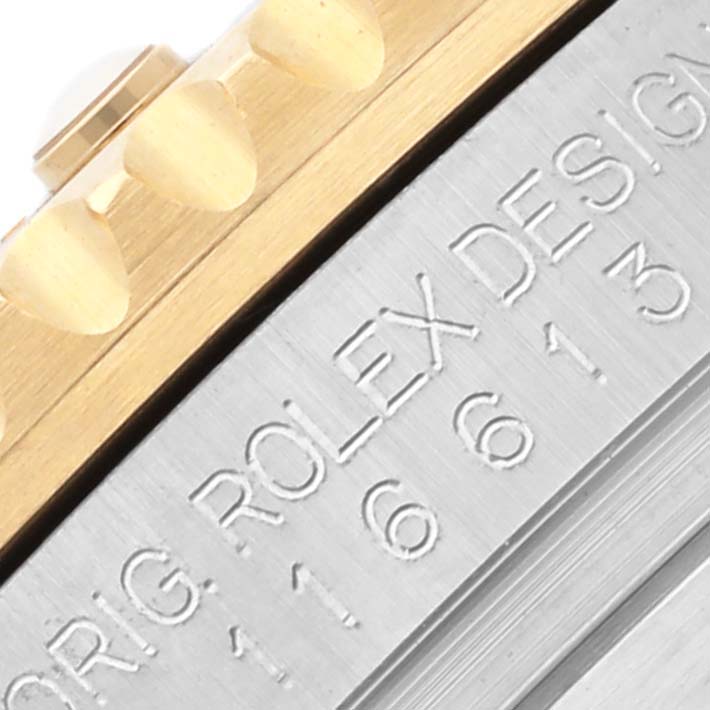 The image shows a close-up of the Rolex Submariner 116613LN Men's Steel and Gold (two tone) Black Dial 116613LN Men's Steel and Gold (two tone) Black Dial's bezel edge and engraved inner rim.