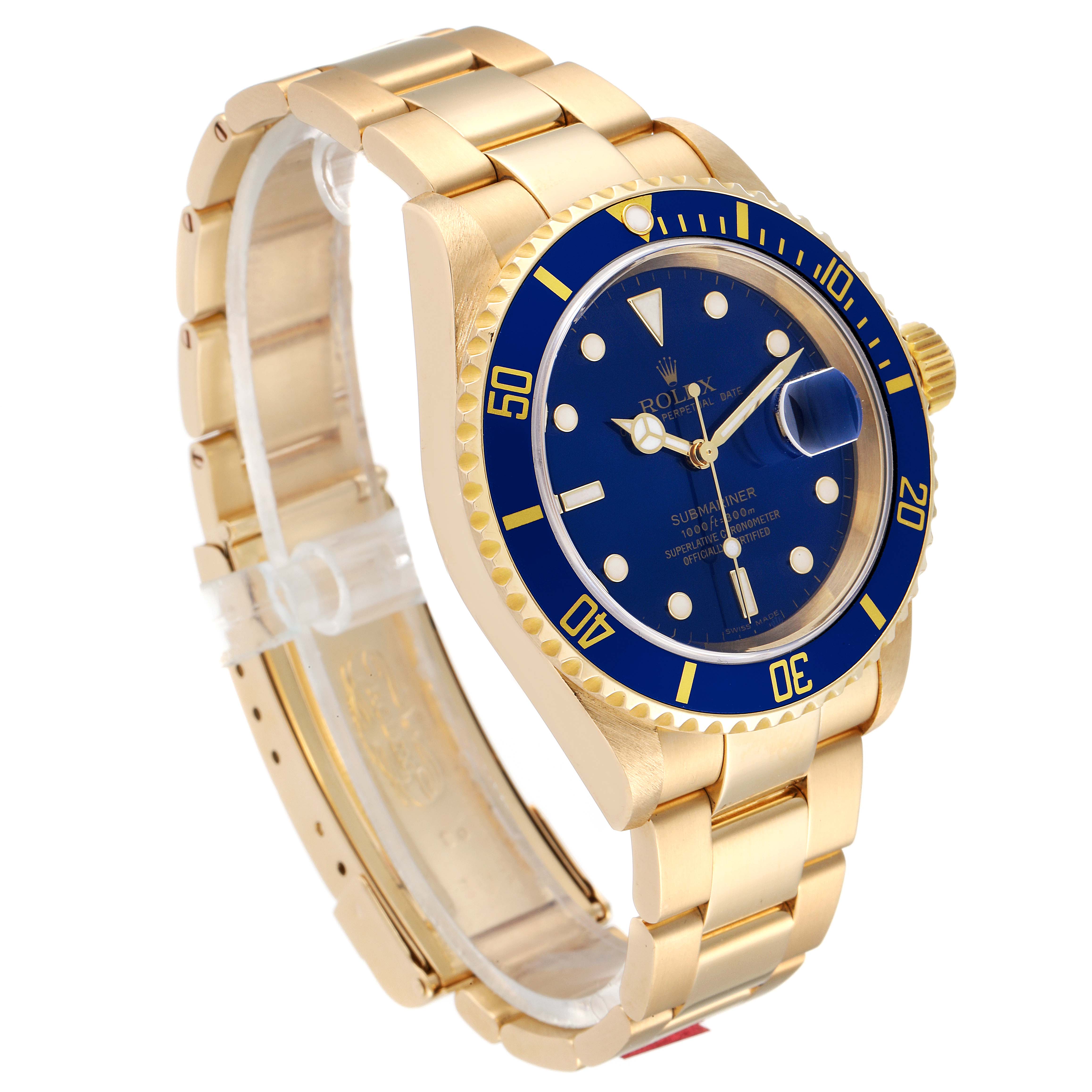 The image shows a gold Rolex Submariner 16618 Men
s Yellow Gold Blue Dial 16618 Men
s Yellow Gold Blue Dial watch at a front three-quarter angle, highlighting its blue dial, bezel, and bracelet.